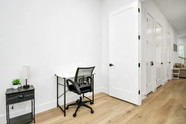 a bedroom with a bed a chandelier and a window