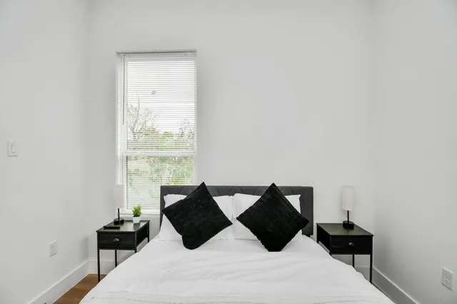 a bedroom with a bed and a dresser