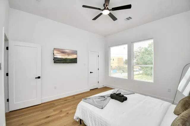 a bedroom with a bed and wooden floor