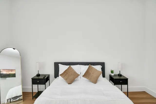 a view of a backyard with a garden and entertaining space