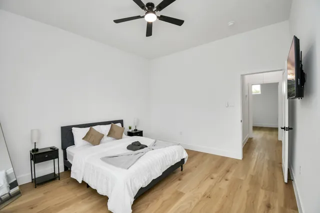 a view of an house with backyard and a tree