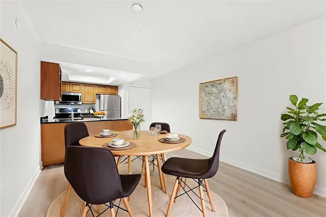 a dining room with furniture and wooden floor