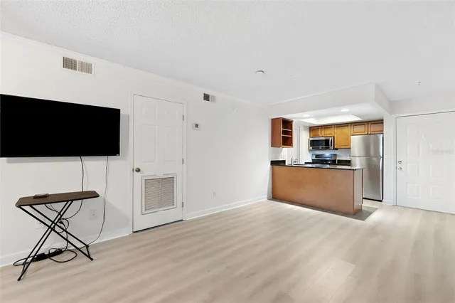 a view of a livingroom with furniture and a kitchen