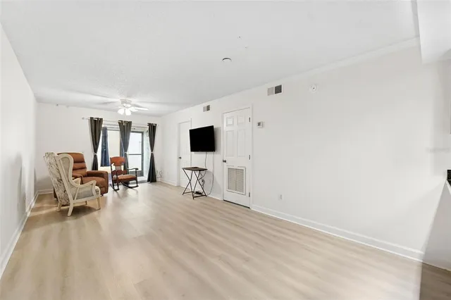 a view of a livingroom with furniture and a flat screen tv