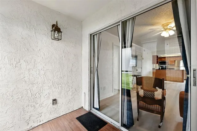 a view of kitchen with furniture and a glass door