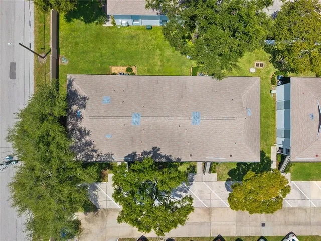 an aerial view of a house with a yard and lake view