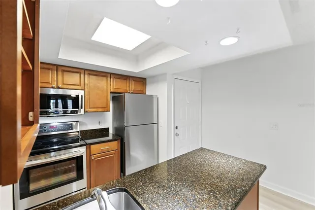 a kitchen with a refrigerator and a stove top oven
