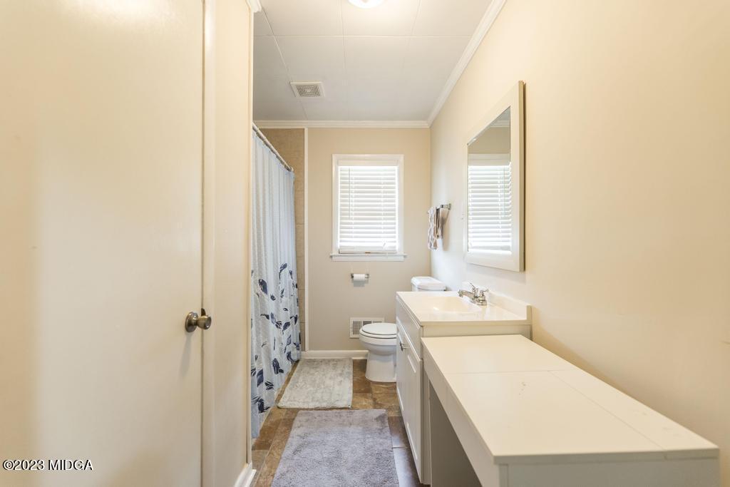 5826 Houston Road Macon, GA 31216 - Photo 23 of 35 a bathroom with a sink a toilet and shower