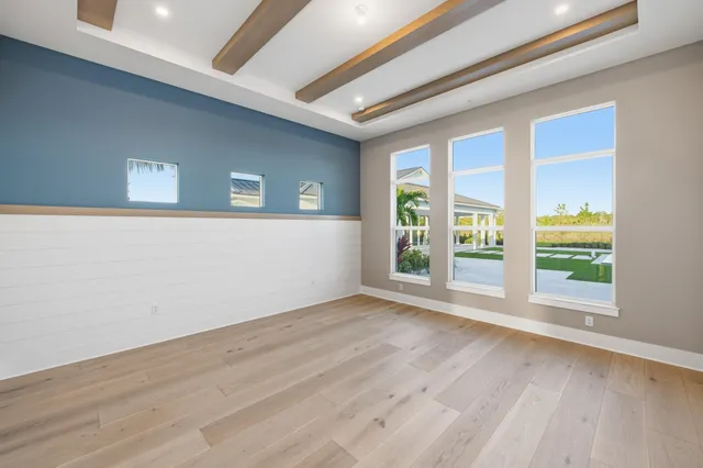 a large kitchen with stainless steel appliances kitchen island a large counter top and a refrigerator