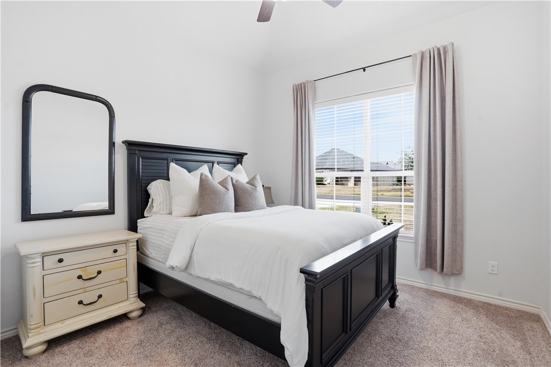 3516 Foxcroft Path Bryan, TX 77808 - Photo 24 of 38 a bed sitting in a bedroom next to a window