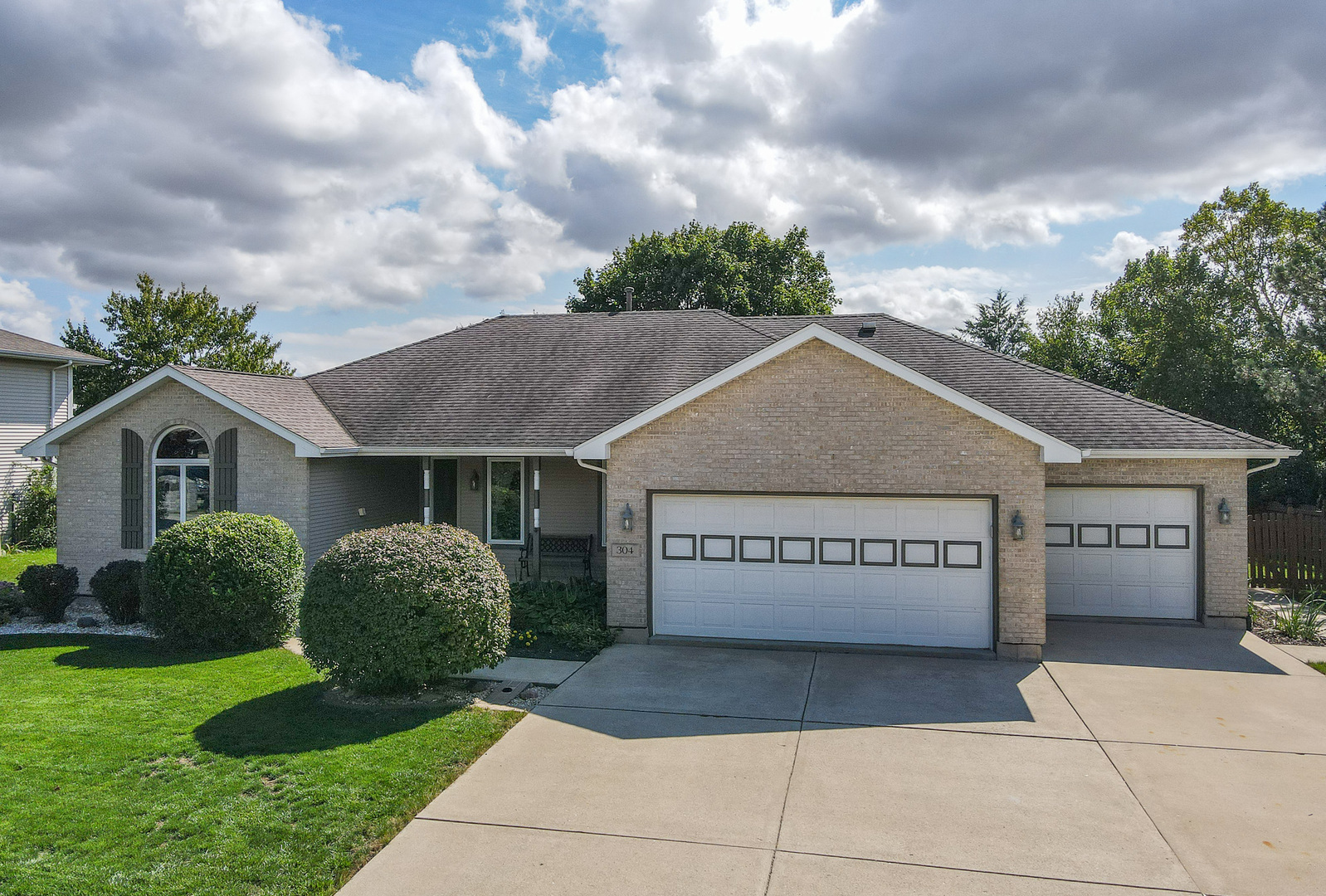 a front view of a house with a garden