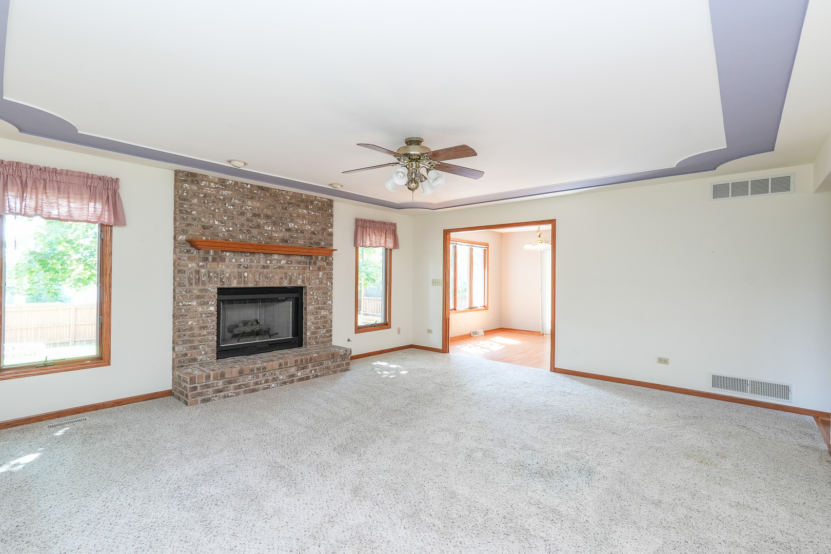 304 Andrea Drive Manhattan, IL 60442 - Photo 24 of 53 an empty room with a fireplace and windows