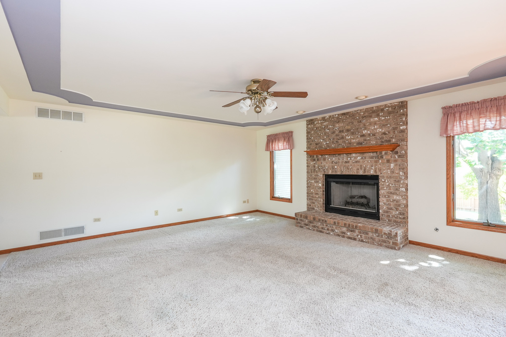 304 Andrea Drive Manhattan, IL 60442 - Photo 28 of 53 an empty room with a fireplace and windows