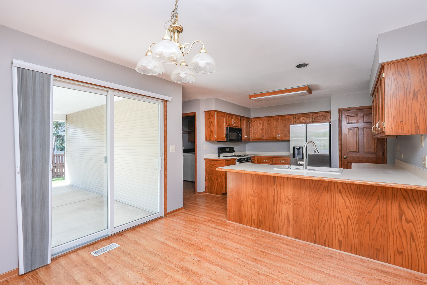 304 Andrea Drive Manhattan, IL 60442 - Photo 30 of 53 a large kitchen with kitchen island a large counter space and stainless steel appliances