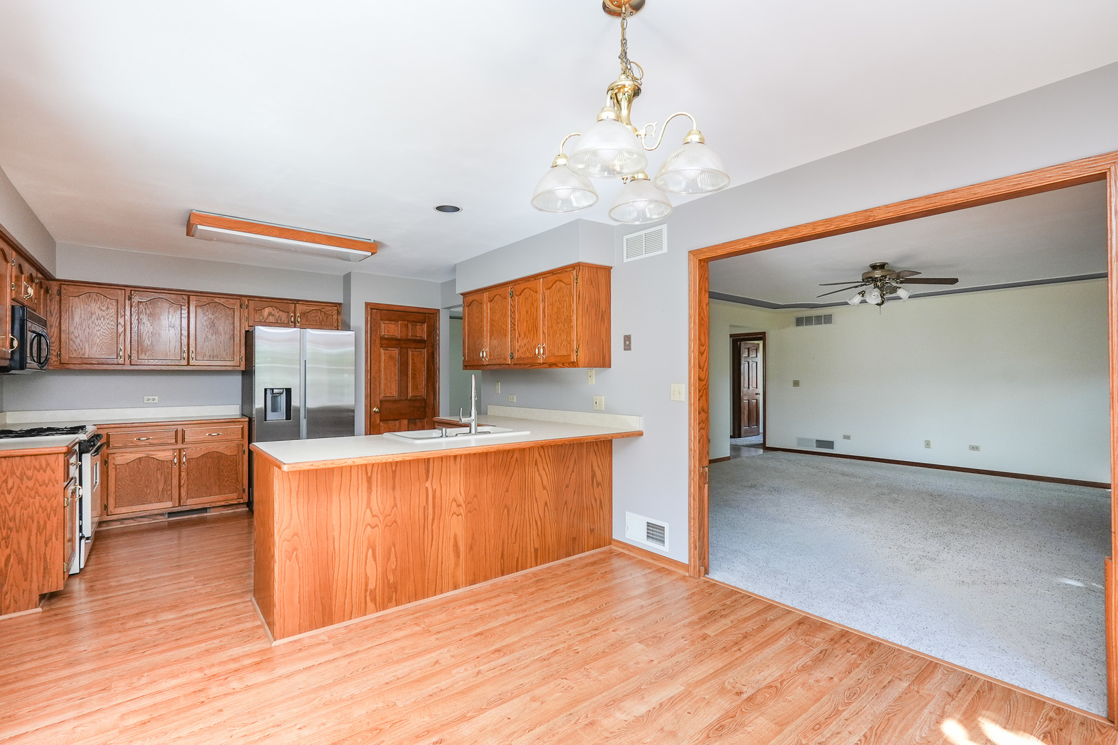 304 Andrea Drive Manhattan, IL 60442 - Photo 32 of 53 a large kitchen with stainless steel appliances a large counter top a sink a stove and a refrigerator
