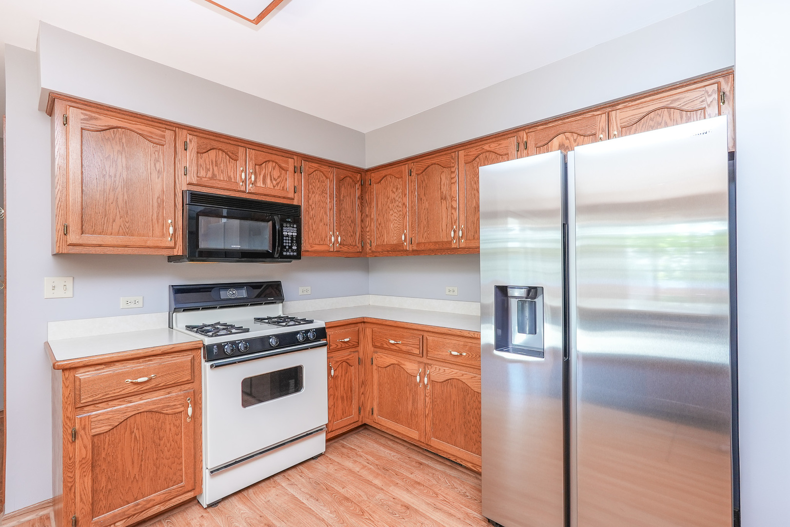 304 Andrea Drive Manhattan, IL 60442 - Photo 34 of 53 a kitchen with a stove a sink and a microwave