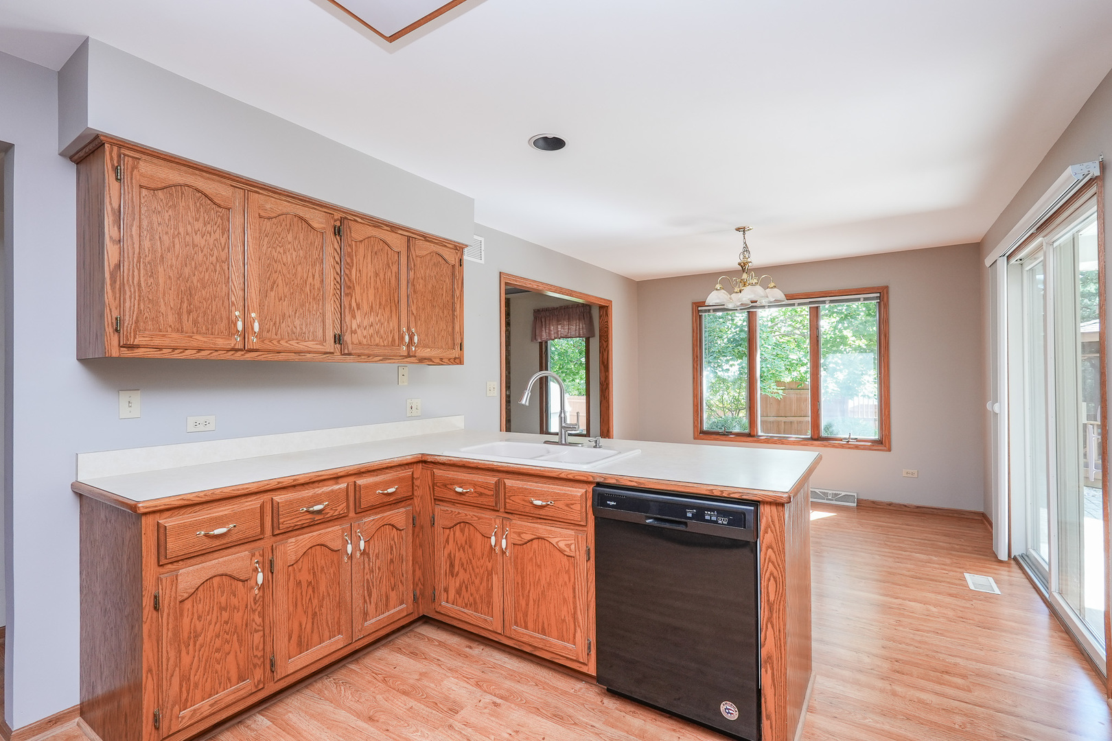 304 Andrea Drive Manhattan, IL 60442 - Photo 35 of 53 a kitchen with granite countertop wooden cabinets a sink and dishwasher
