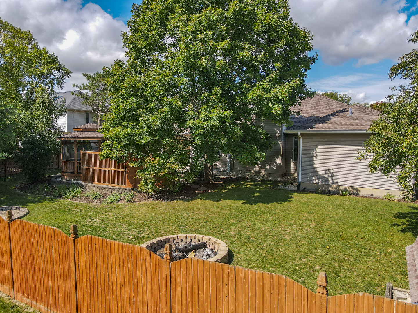 304 Andrea Drive Manhattan, IL 60442 - Photo 6 of 53 a view of a house with backyard porch and sitting area