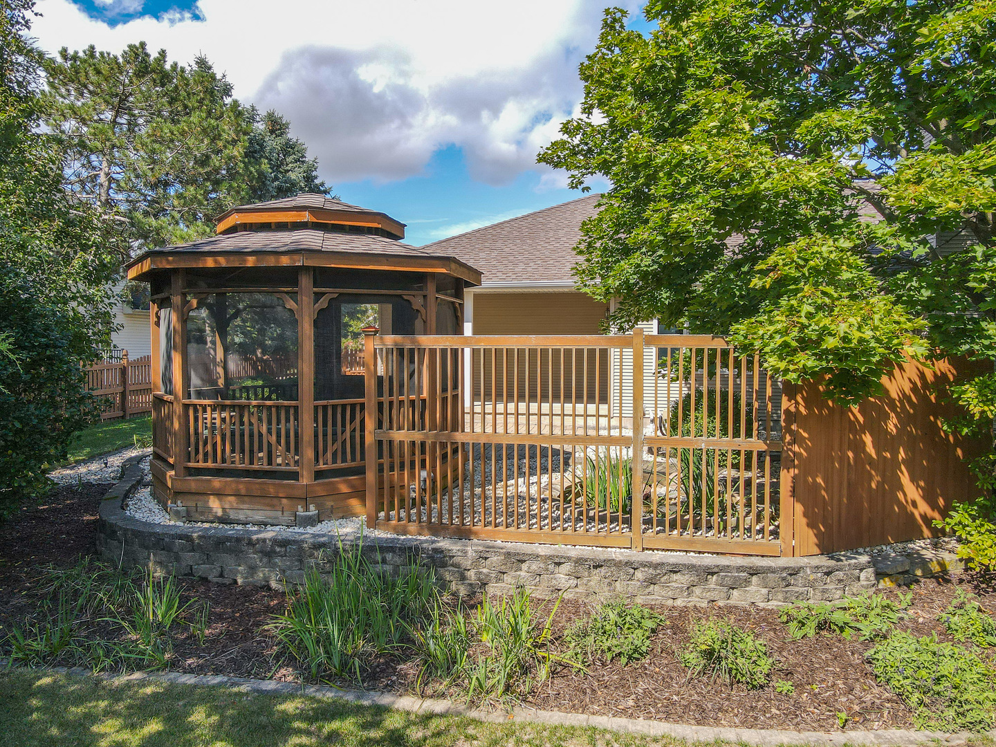 304 Andrea Drive Manhattan, IL 60442 - Photo 7 of 53 a view of a brick house with a small yard and large trees