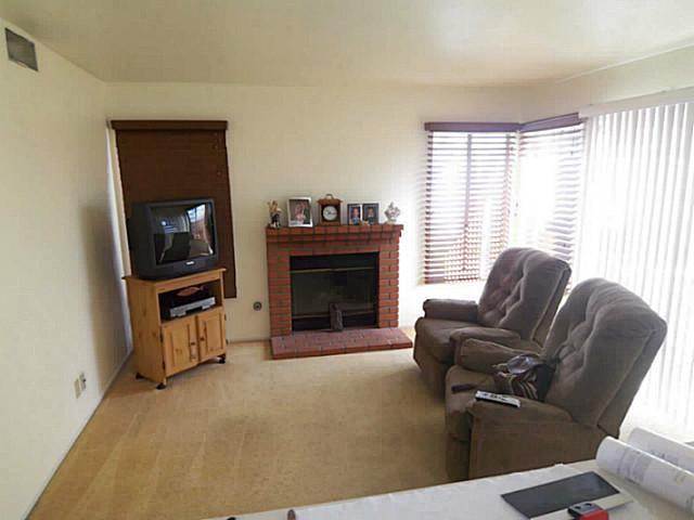 1630 Promontory Ridge Way Vista, CA 92081 - Photo 2 of 13 The family room with warm fireplace enjoys a counter connecting it to the kitchen.