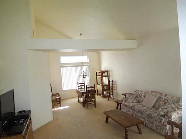 1630 Promontory Ridge Way Vista, CA 92081 - Photo 3 of 13 The living room and dining area are a large, bright area.