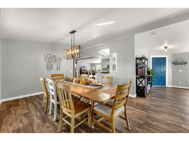 a dining room with furniture and wooden floor