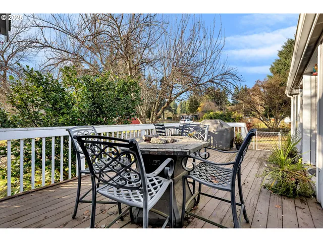 a view of a dinning table and chairs on the deck