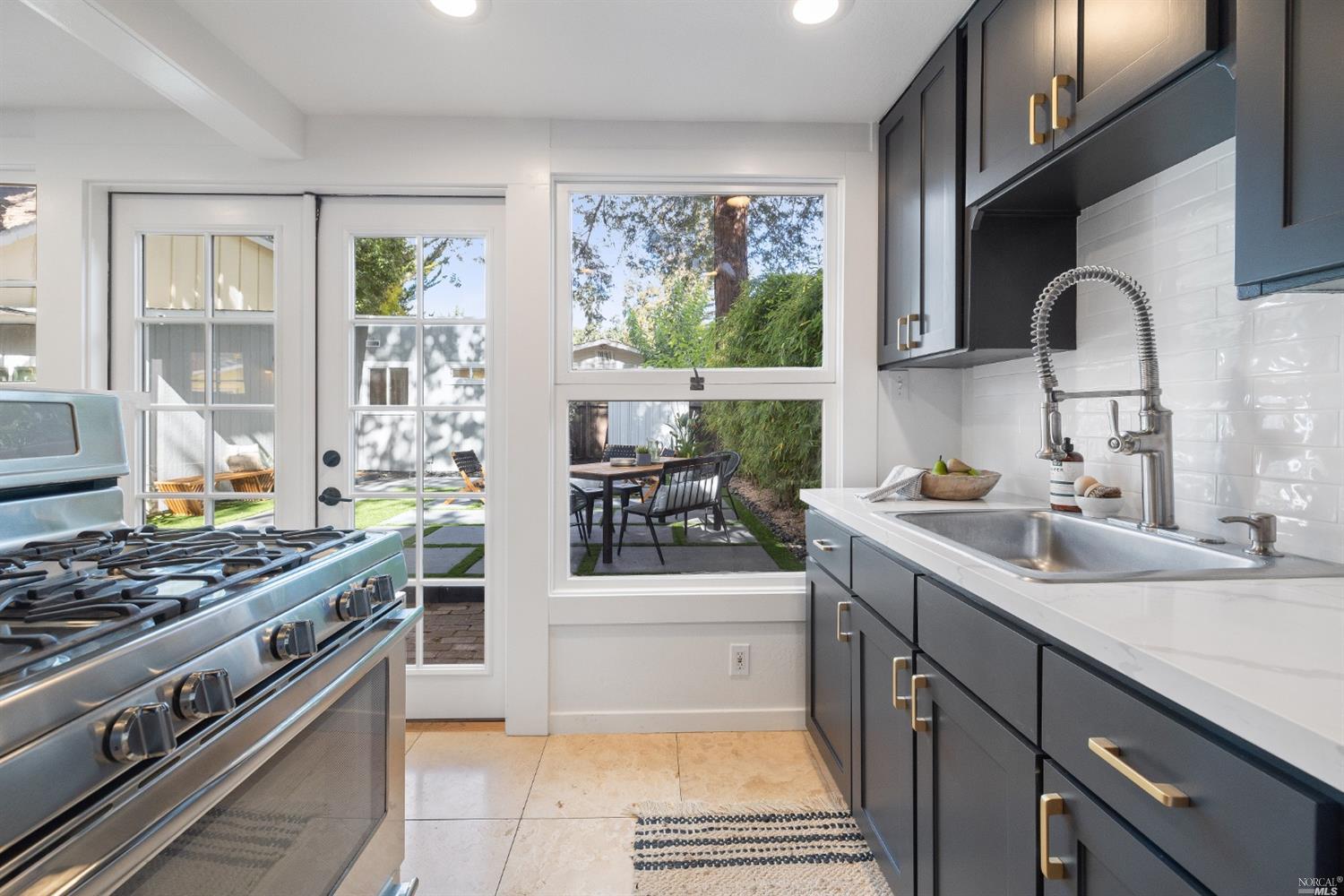 27 Laurel Avenue San Anselmo, CA 94960 - Photo 13 of 52 a kitchen with stainless steel appliances a sink stove and cabinets