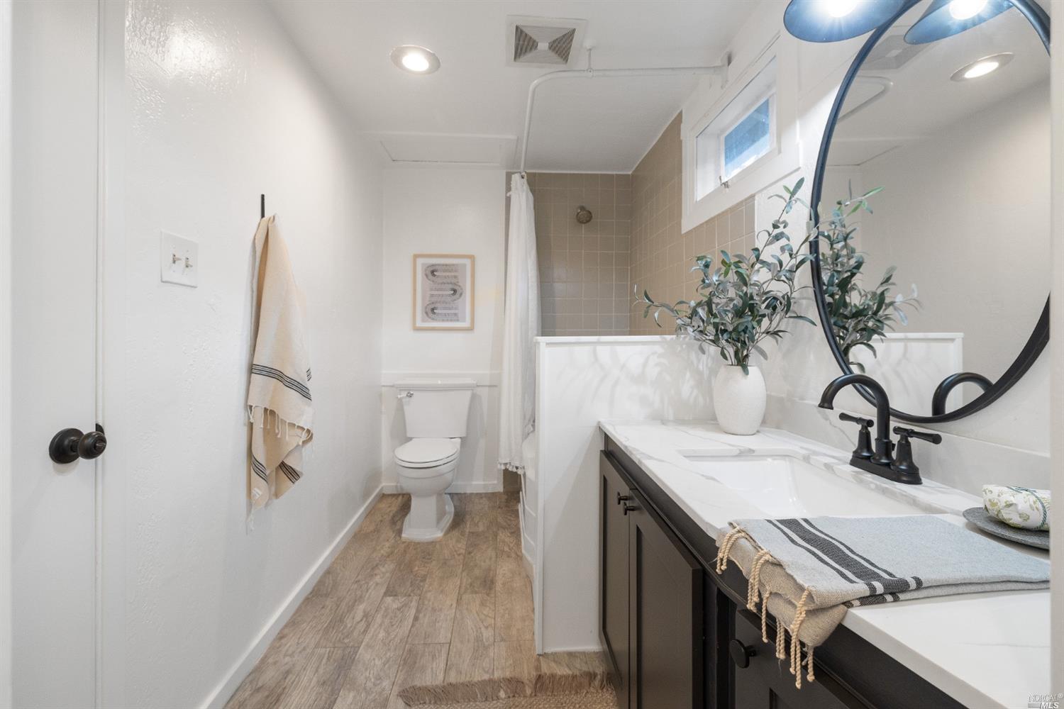 27 Laurel Avenue San Anselmo, CA 94960 - Photo 17 of 52 a view of a bathroom with a sink and mirror
