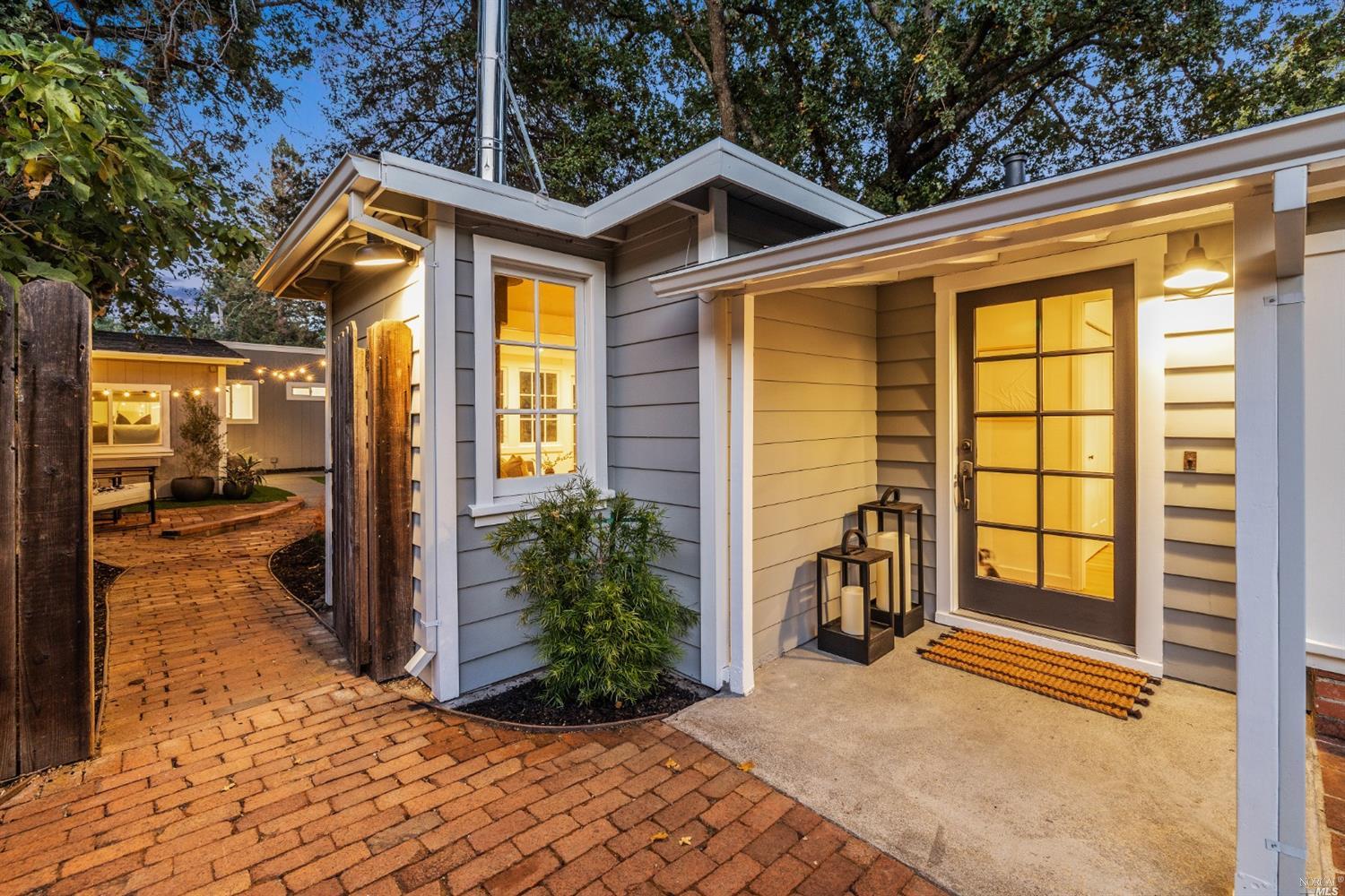 27 Laurel Avenue San Anselmo, CA 94960 - Photo 5 of 52 a view of a house with large windows and a yard with plants
