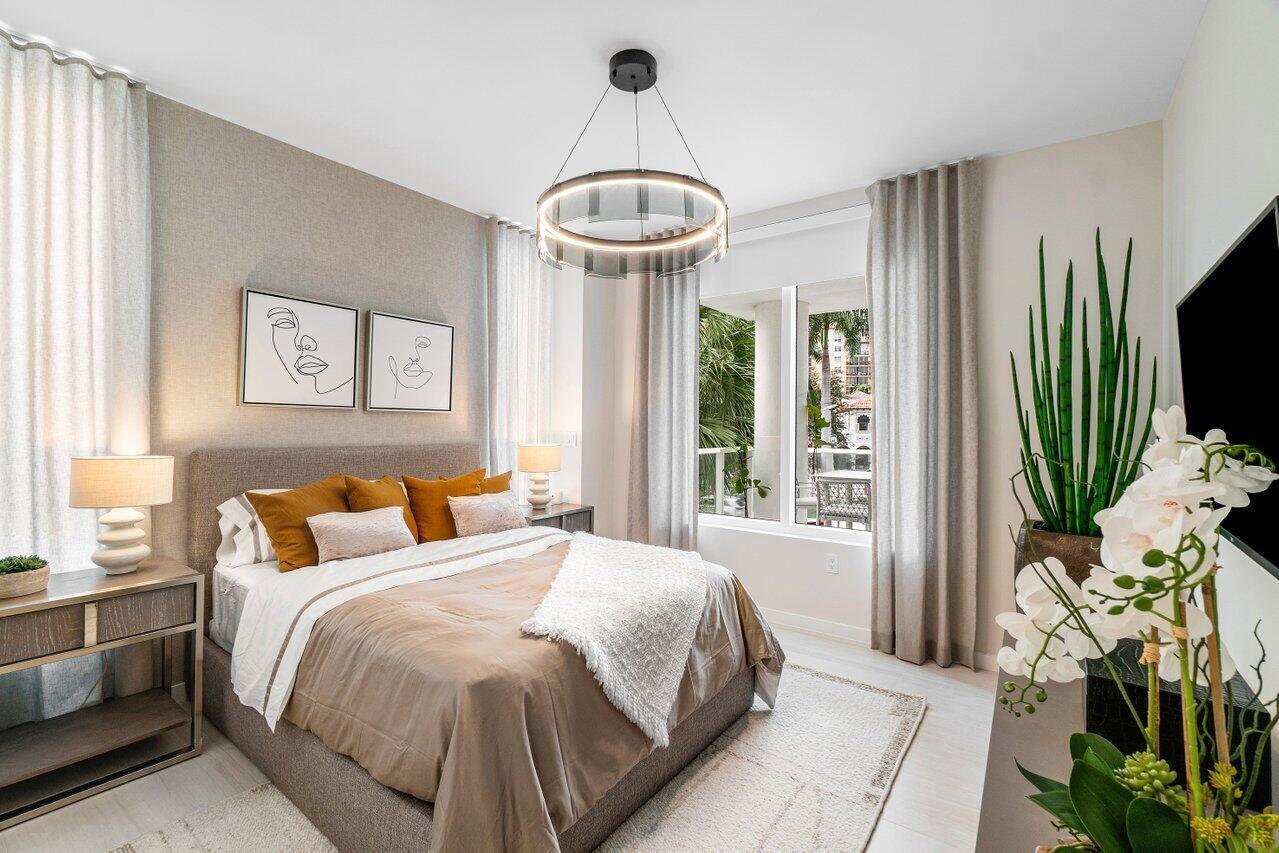200 Southeast Mizner Boulevard, Unit 211 Boca Raton, FL 33432 - Photo 22 of 67 a bedroom with a bed and a flat screen tv