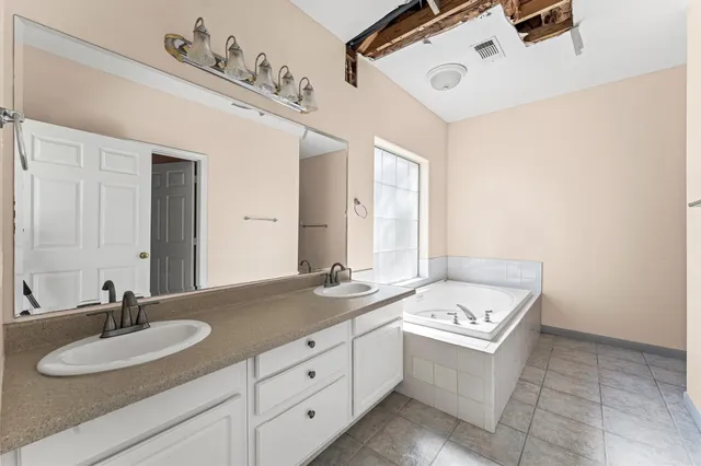 a bathroom with a double vanity sink and mirror