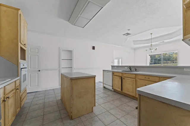 a kitchen with stainless steel appliances granite countertop a sink and cabinets