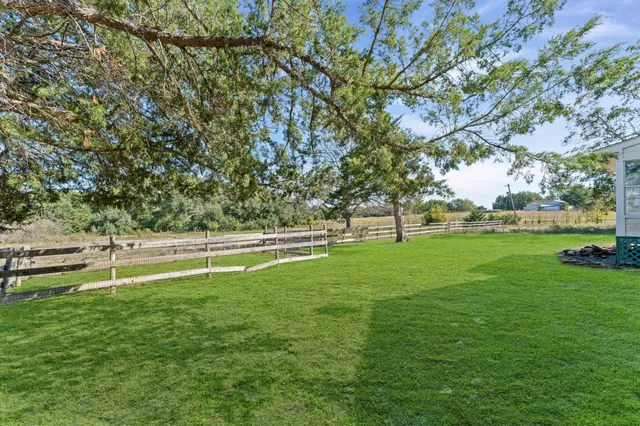 a view of field with grass and trees