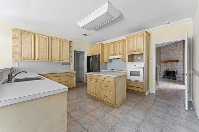 a kitchen with white cabinets and white appliances