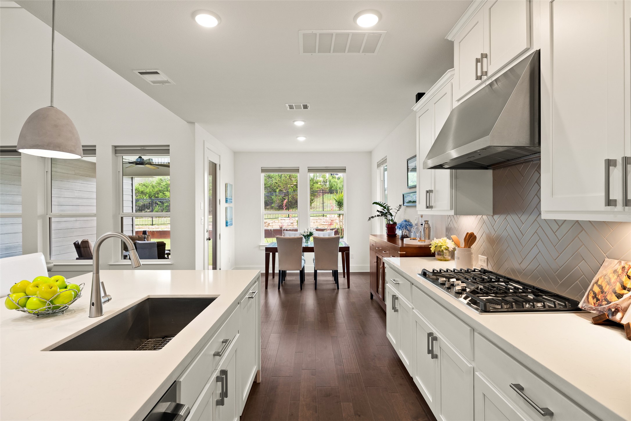 299 Tierra Trail Dripping Springs, TX 78620 - Photo 20 of 40 a kitchen with a table chairs stove and cabinets