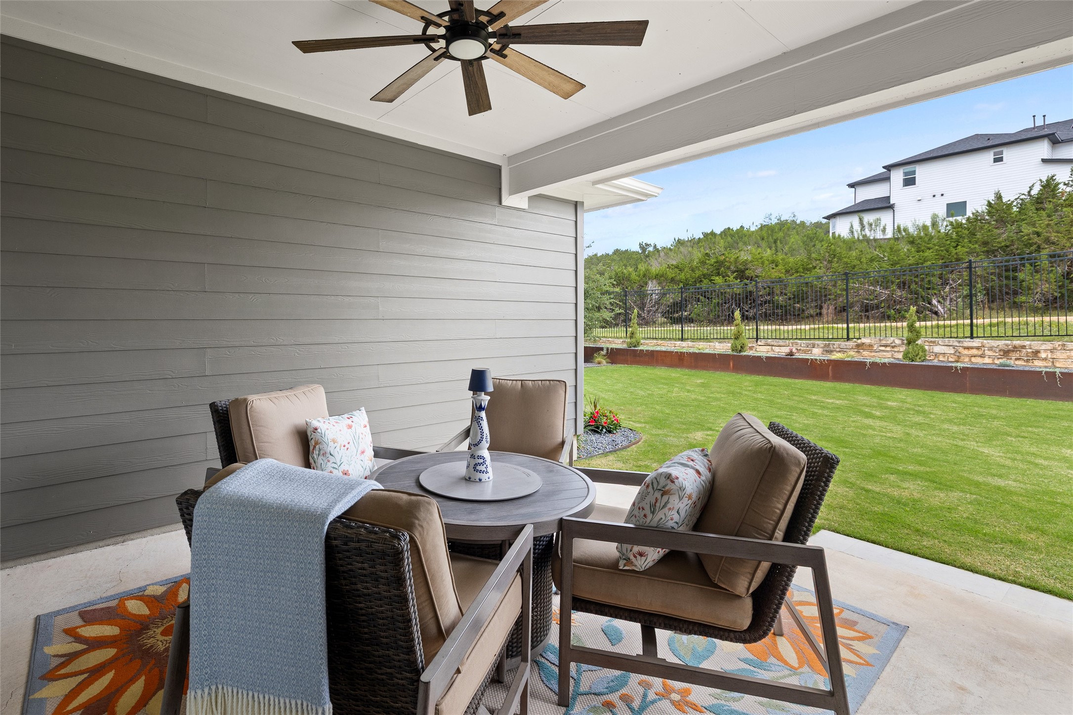 299 Tierra Trail Dripping Springs, TX 78620 - Photo 34 of 40 a view of a patio with a table chairs and a yard