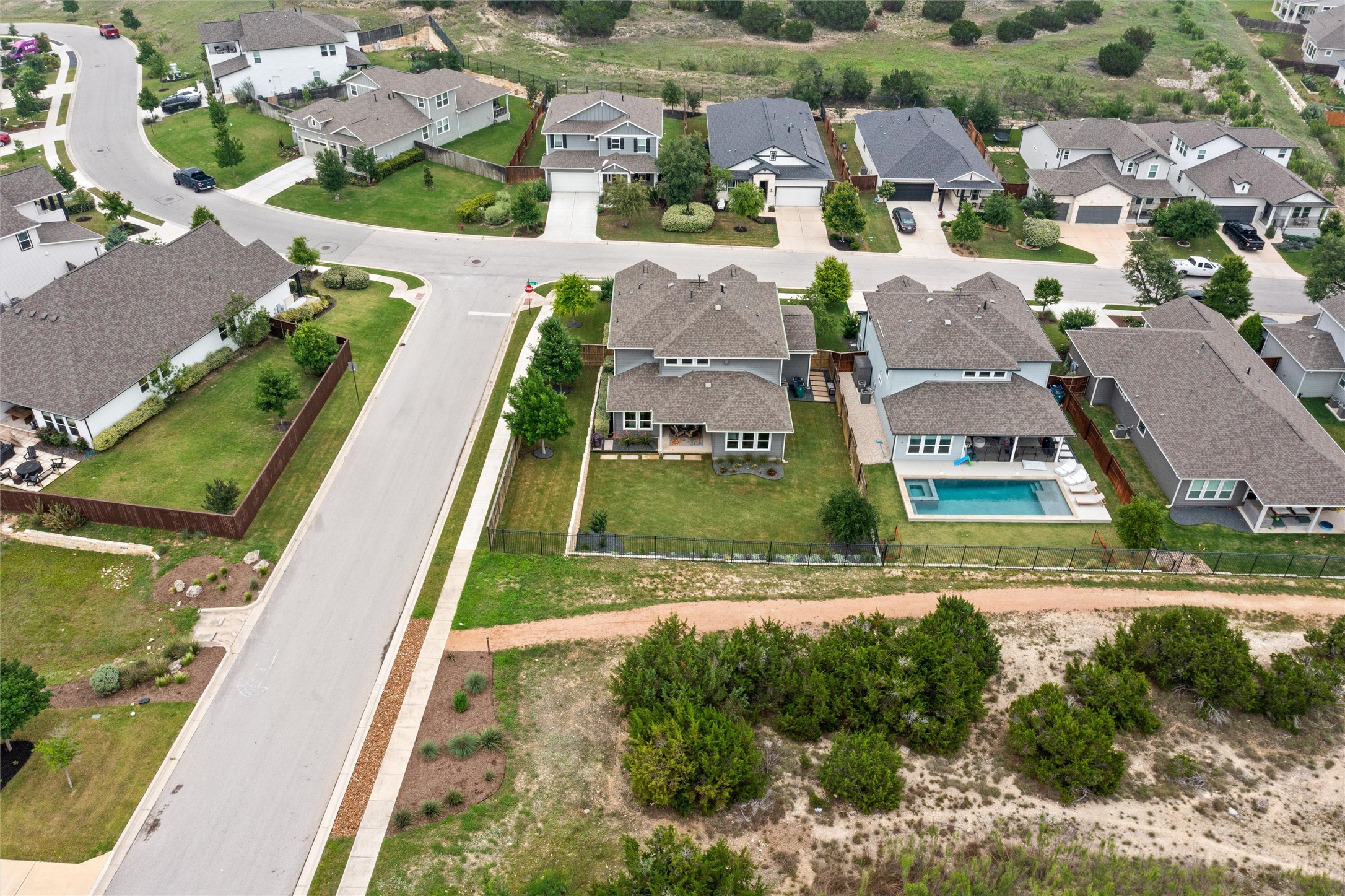 299 Tierra Trail Dripping Springs, TX 78620 - Photo 39 of 40 an aerial view of residential houses with outdoor space and swimming pool