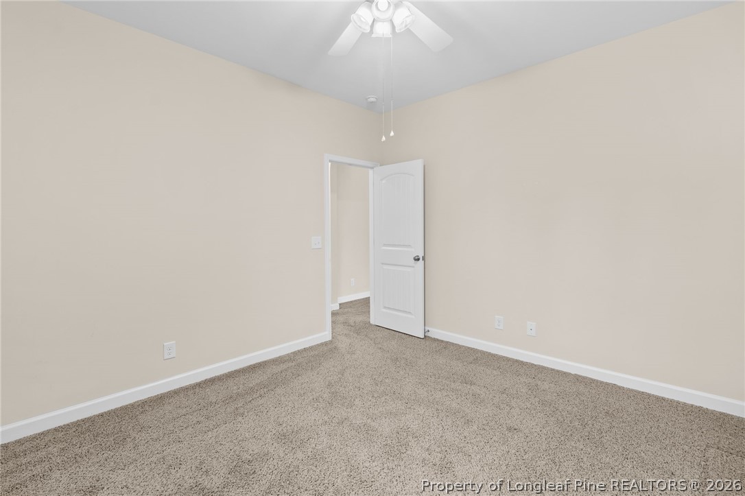 216 Meherrin Loop Raeford, NC 28376 - Photo 31 of 38 an empty room with a ceiling fan and carpet