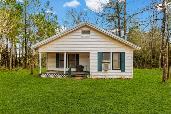 a front view of house with a garden and patio