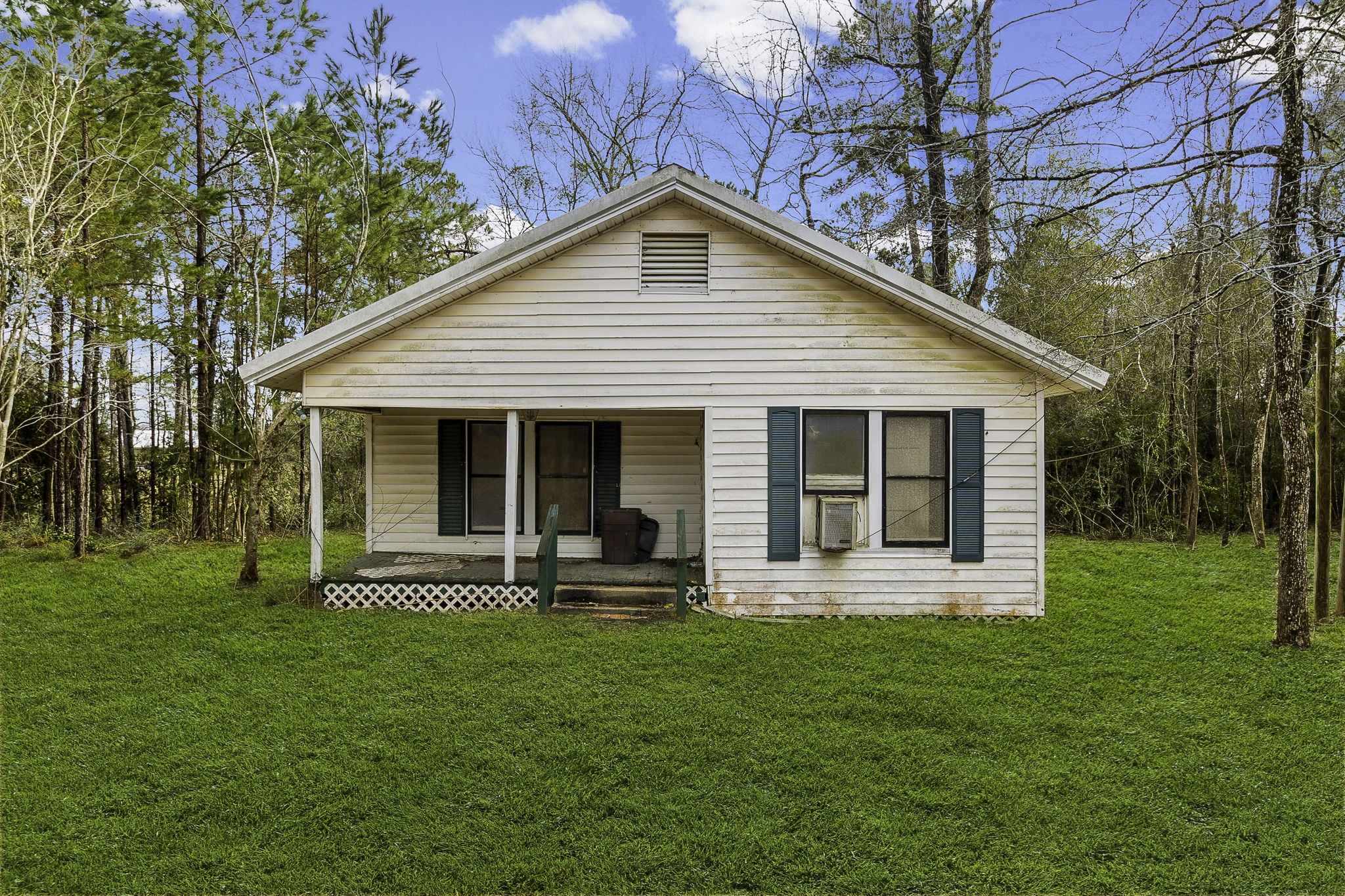 a front view of house with a garden and patio