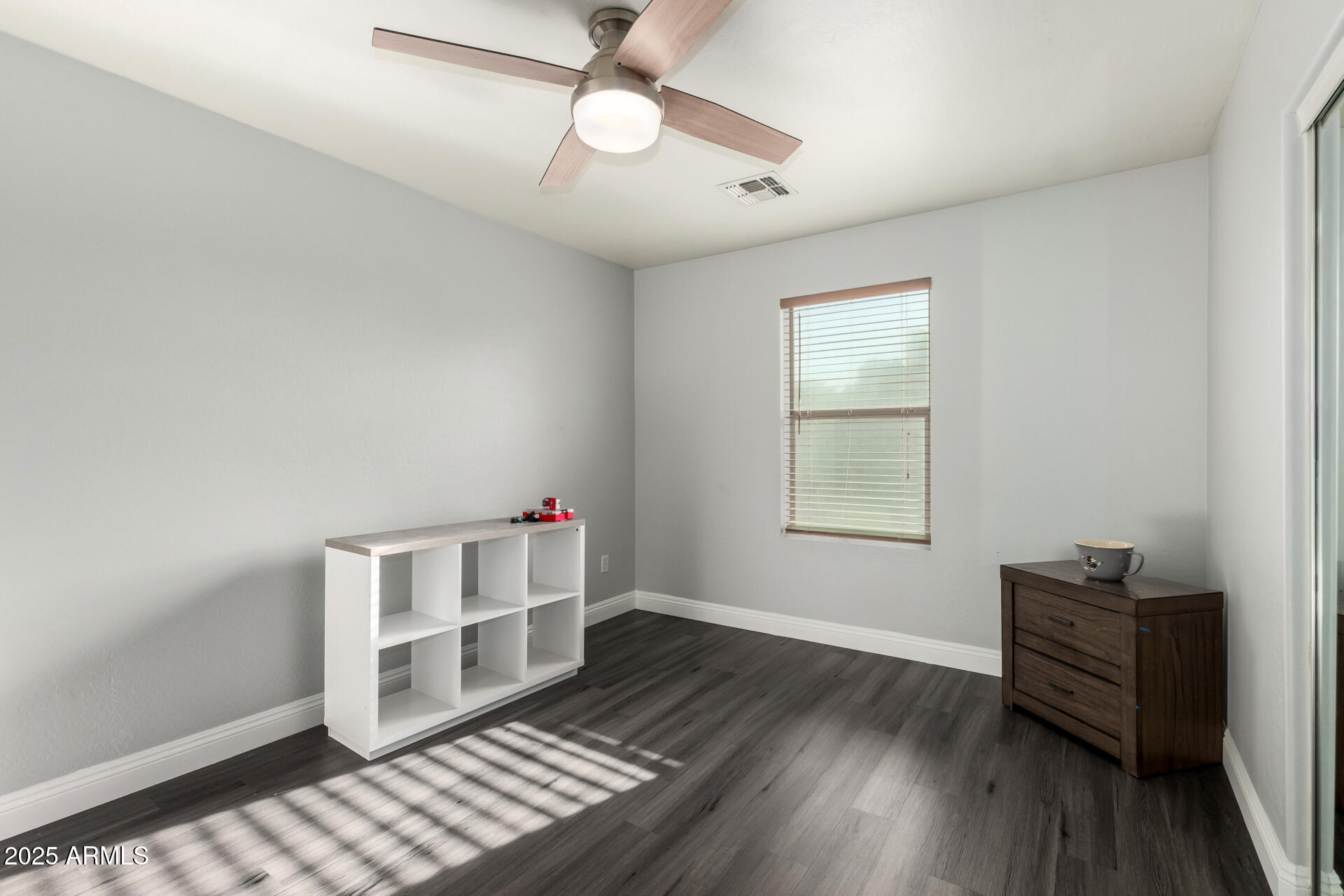 9415 West Eaton Road Phoenix, AZ 85037 - Photo 26 of 36 wooden floor in an empty room with a window
