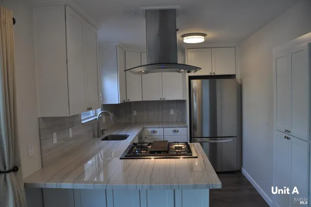 a kitchen with a refrigerator and a stove