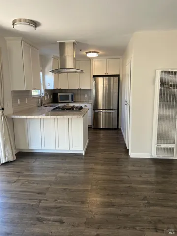 a kitchen with stainless steel appliances a refrigerator and a stove