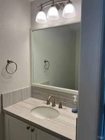 a bathroom with a sink and mirror