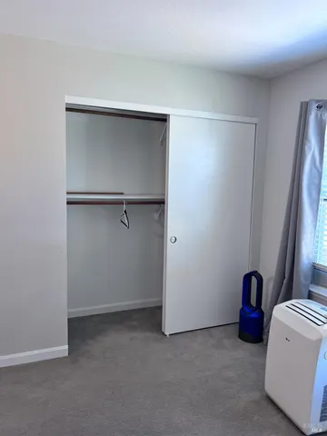 a view of an empty room with a closet