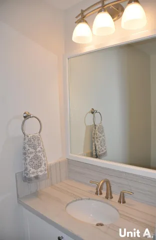 a bathroom with a sink and vanity