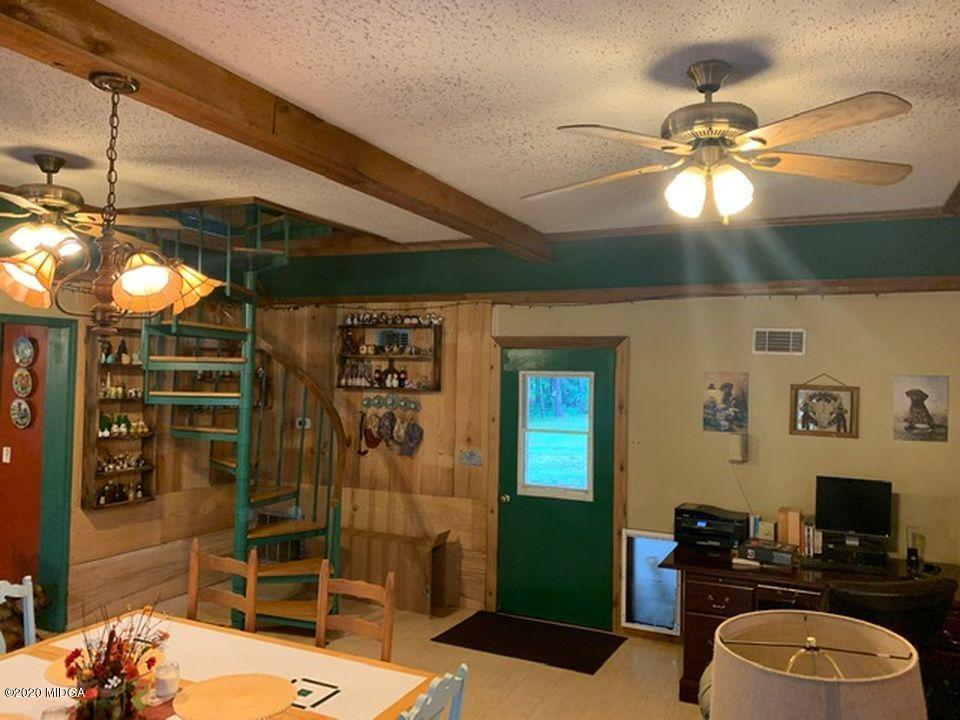 410 Holloman Road Gray, GA 31032 - Photo 14 of 24 a bedroom with a bed and a chandelier