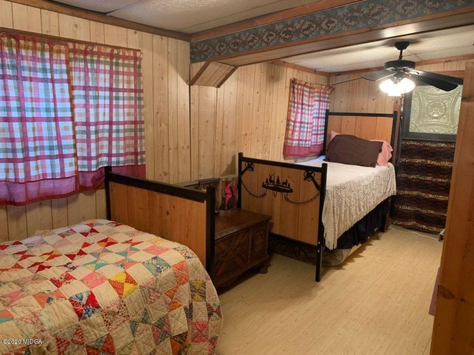 410 Holloman Road Gray, GA 31032 - Photo 3 of 24 a bedroom with a bed and a dresser