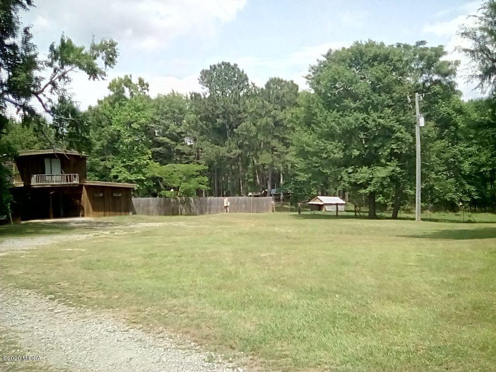 410 Holloman Road Gray, GA 31032 - Photo 22 of 24 a view of a swimming pool with a yard and trees